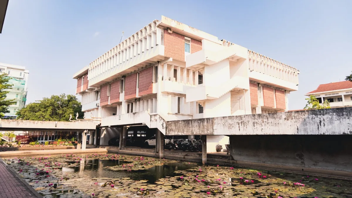 The Institute of Foreign Languages main building, designed by Vann Molyvann, above a lily pond